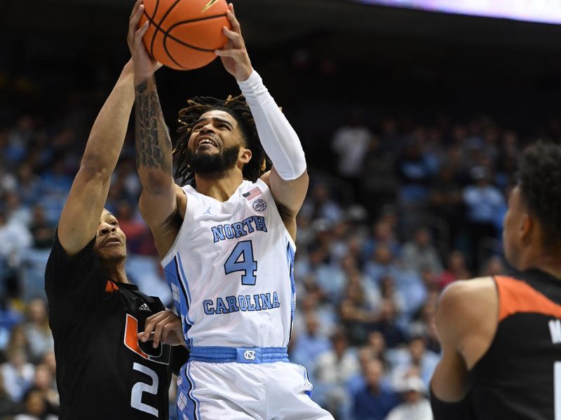 Feb 13, 2023; Chapel Hill, North Carolina, USA; North Carolina Tar Heels guard R.J. Davis (4) shoots as Miami (Fl) Hurricanes guard Isaiah Wong (2) defends in the second half at Dean E. Smith Center. Mandatory Credit: Bob Donnan-USA TODAY Sports