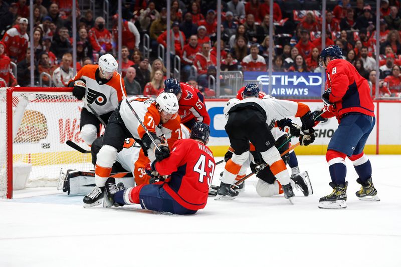 Mar 1, 2024; Washington, District of Columbia, USA; Philadelphia Flyers and Washington Capitals players battle for the puck in front of Flyers goaltender Samuel Ersson (33) in the first period at Capital One Arena. Mandatory Credit: Geoff Burke-USA TODAY Sports