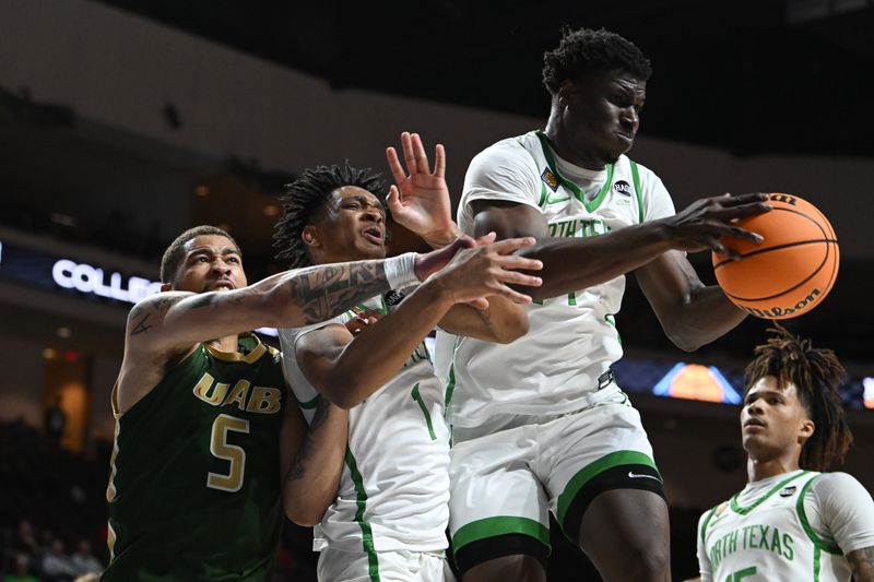 Mar 30, 2023; Las Vegas, NV, USA; UAB Blazers forward KJ Buffen (5) and North Texas Mean Green guard Aaron Scott (1) and forward Moulaye Sissoko (14) battle for a rebound in the first half at Orleans Arena. Mandatory Credit: Candice Ward-USA TODAY Sports