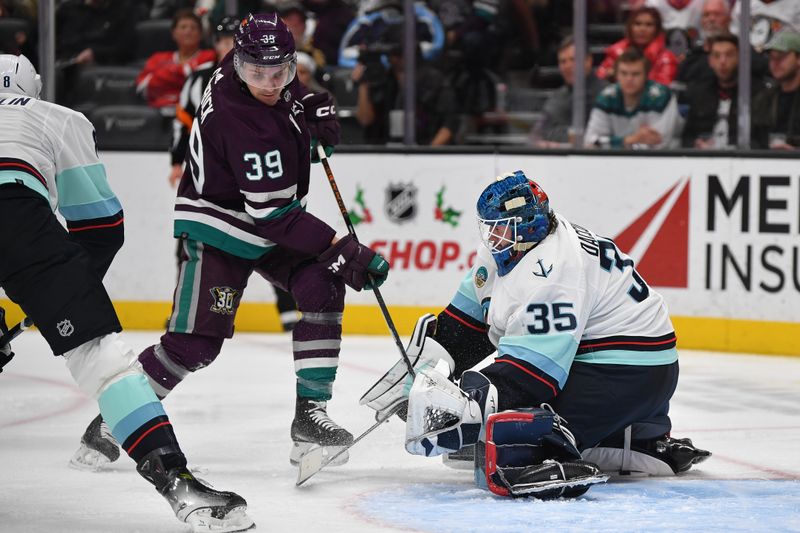 Dec 23, 2023; Anaheim, California, USA; Seattle Kraken goaltender Joey Daccord (35) blocks a shot against Anaheim Ducks center Sam Carrick (39) during the second period at Honda Center. Mandatory Credit: Gary A. Vasquez-USA TODAY Sports