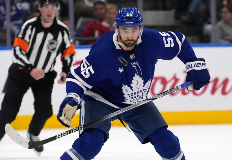 Sep 27, 2025; Toronto, Ontario, CAN; Toronto Maple Leafs forward Nicolas Roy (55) keeps his eye on the puck during the third period against the Montreal Canadiens at Scotiabank Arena. Mandatory Credit: John E. Sokolowski-Imagn Images