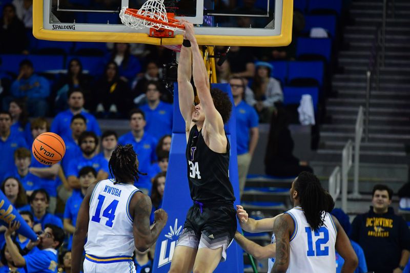 January 14, 2024; Los Angeles, California, USA; Washington Huskies center Braxton Meah (34) dunks for the basket against the UCLA Bruins during the second half at Pauley Pavilion. Mandatory Credit: Gary A. Vasquez-USA TODAY Sports