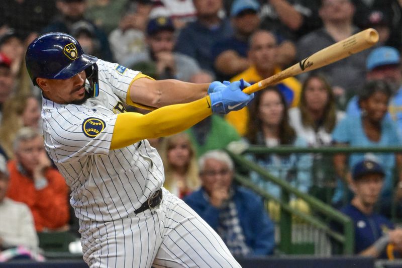 Jun 1, 2024; Milwaukee, Wisconsin, USA; Milwaukee Brewers shortstop Willy Adames (27) hits a single to drive in two runs against the Chicago White Sox in the seventh inning at American Family Field. Mandatory Credit: Benny Sieu-USA TODAY Sports