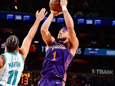 PHOENIX, AZ - DECEMBER 29: Devin Booker #1 of the Phoenix Suns shoots the ball during the game against the Charlotte Hornets on December 29 2023 at Footprint Center in Phoenix, Arizona. NOTE TO USER: User expressly acknowledges and agrees that, by downloading and or using this photograph, user is consenting to the terms and conditions of the Getty Images License Agreement. Mandatory Copyright Notice: Copyright 2023 NBAE (Photo by Barry Gossage/NBAE via Getty Images)