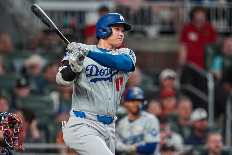 Sep 15, 2024; Cumberland, Georgia, USA; Los Angeles Dodgers designated hitter Shohei Ohtani (17) doubles to drive in a run against the Atlanta Braves during the fifth inning at Truist Park. Mandatory Credit: Dale Zanine-Imagn Images