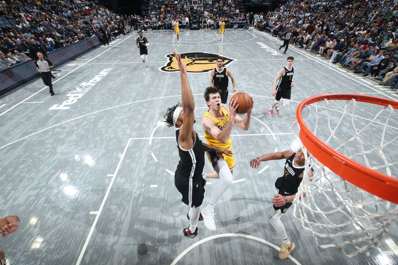 MEMPHIS, TN - MARCH 27: Austin Reaves #15 of the Los Angeles Lakers drives to the basket during the game against the Memphis Grizzlies on March 27, 2024 at FedExForum in Memphis, Tennessee. NOTE TO USER: User expressly acknowledges and agrees that, by downloading and or using this photograph, User is consenting to the terms and conditions of the Getty Images License Agreement. Mandatory Copyright Notice: Copyright 2024 NBAE (Photo by Joe Murphy/NBAE via Getty Images)