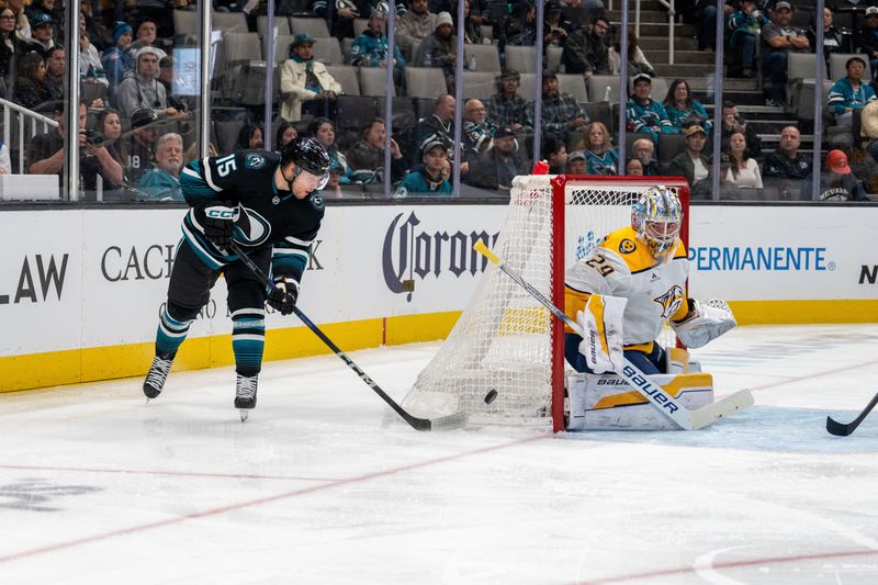 Jan 23, 2025; San Jose, California, USA;  San Jose Sharks right wing Nikolai Kovalenko (15) flicks a pass in front of the net against Nashville Predators goaltender Justus Annunen (29) at SAP Center at San Jose. Mandatory Credit: Neville E. Guard-Imagn Images