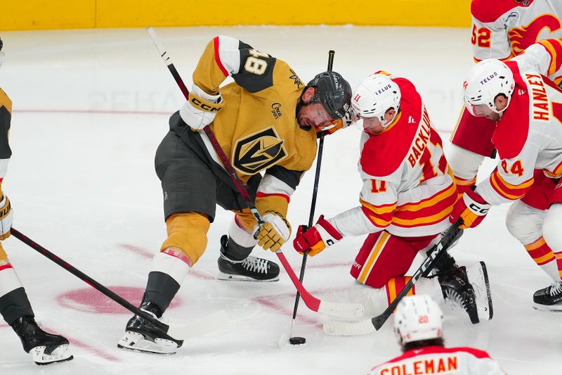 Oct 18, 2025; Las Vegas, Nevada, USA; Vegas Golden Knights center Tomas Hertl (48) takes a face off against Calgary Flames center Mikael Backlund (11) during the third period at T-Mobile Arena. Mandatory Credit: Stephen R. Sylvanie-Imagn Images