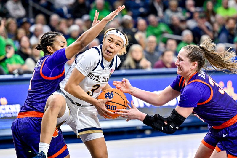 Feb 22, 2024; South Bend, Indiana, USA; Notre Dame Fighting Irish guard Hannah Hidalgo (3) goes up for a shot as Clemson Tigers guard Dayshanette Harris (1) and guard Danielle Rauch (33) defend in the second half at the Purcell Pavilion. Mandatory Credit: Matt Cashore-USA TODAY Sports