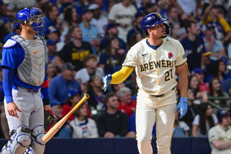 May 27, 2024; Milwaukee, Wisconsin, USA; Milwaukee Brewers shortstop Willy Adames (27) watches after hitting a 3-run home run in the eighth inning as Chicago Cubs catcher Miguel Amaya (9) looks on at American Family Field. Mandatory Credit: Benny Sieu-USA TODAY Sports