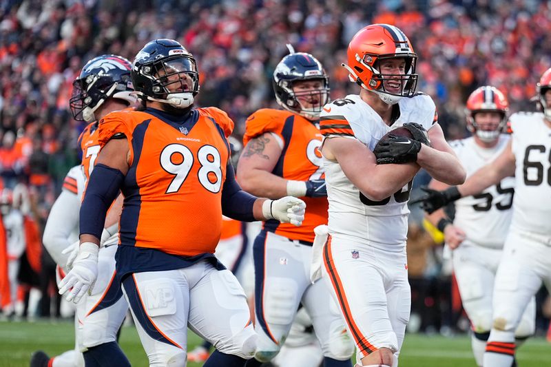 Cleveland Browns tight end Harrison Bryant, right, celebrates after scoring as Denver Broncos defensive tackle Mike Purcell (98) watches during the second half of an NFL football game on Sunday, Nov. 26, 2023, in Denver. (AP Photo/Jack Dempsey)