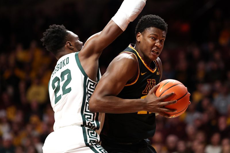 Feb 6, 2024; Minneapolis, Minnesota, USA; Minnesota Golden Gophers forward Pharrel Payne (21) works around Michigan State Spartans center Mady Sissoko (22) during the first half at Williams Arena. Mandatory Credit: Matt Krohn-USA TODAY Sports