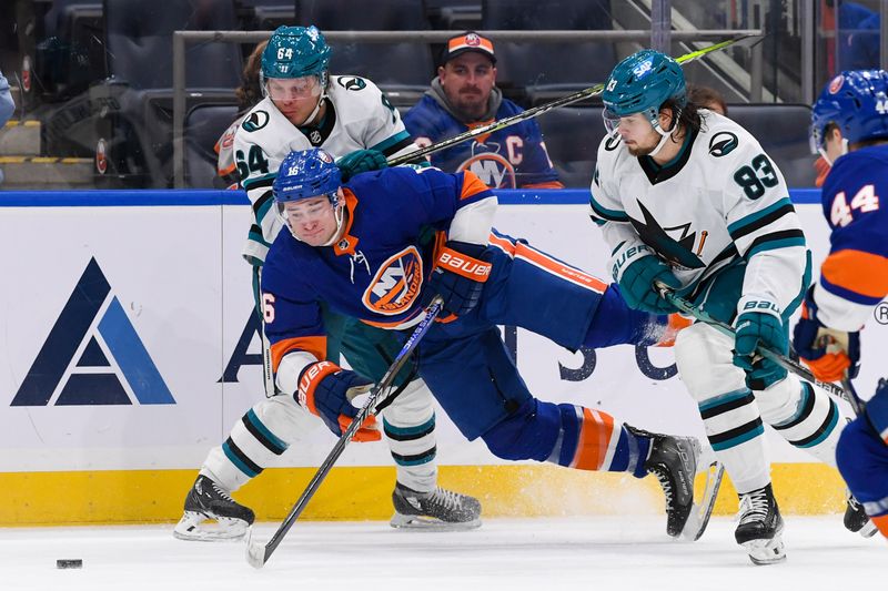 Dec 5, 2023; Elmont, New York, USA; San Jose Sharks right wing Mitchell Russell (64) and New York Islanders right wing Julien Gauthier (16) battle for the puck during the second period at UBS Arena. Mandatory Credit: Dennis Schneidler-USA TODAY Sports