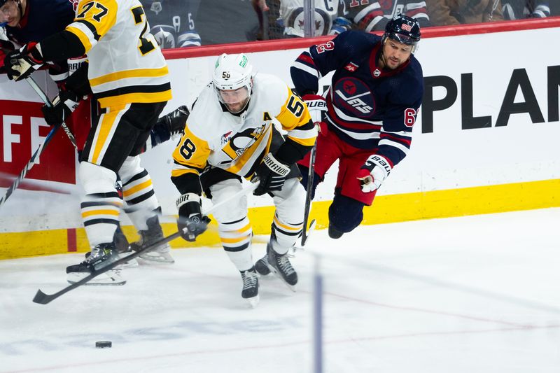 Feb 10, 2024; Winnipeg, Manitoba, CAN;  Pittsburgh Penguins defenseman Kris Letang (58) skates away from Winnipeg Jets forward Nino Niederreiter (62) during the third period at Canada Life Centre. Mandatory Credit: Terrence Lee-USA TODAY Sports