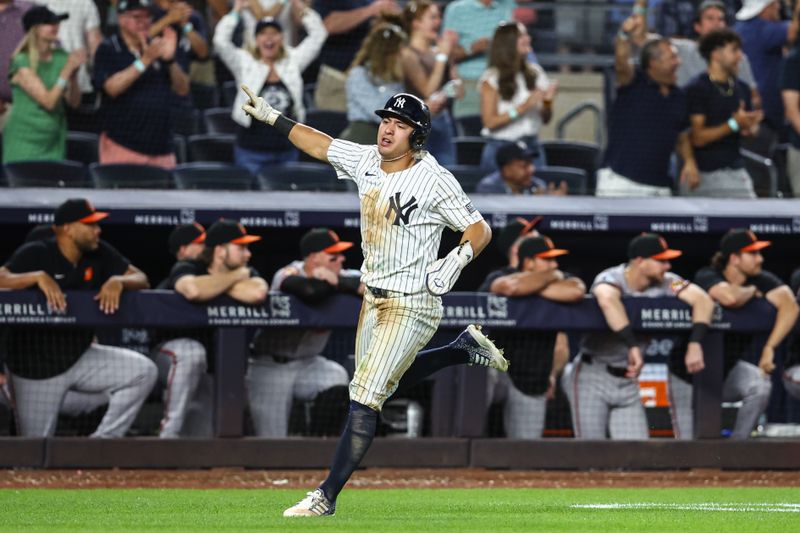 Jun 19, 2024; Bronx, New York, USA;  New York Yankees shortstop Anthony Volpe (11) scores the tying run in the ninth inning against the Baltimore Orioles at Yankee Stadium. Mandatory Credit: Wendell Cruz-USA TODAY Sports