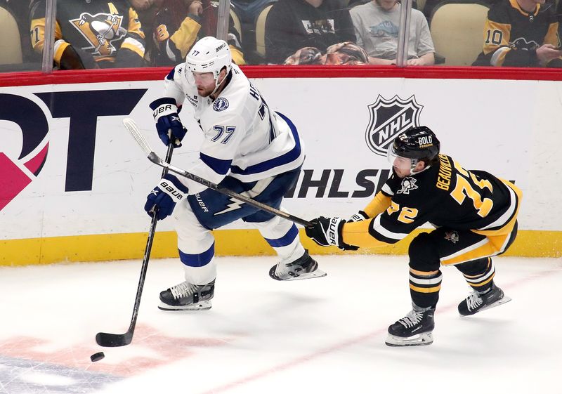 Nov 19, 2024; Pittsburgh, Pennsylvania, USA; Tampa Bay Lightning defenseman Victor Hedman (77) moves the puck against Pittsburgh Penguins left wing Anthony Beauvillier (72) in overtime at PPG Paints Arena. Mandatory Credit: Charles LeClaire-Imagn Images