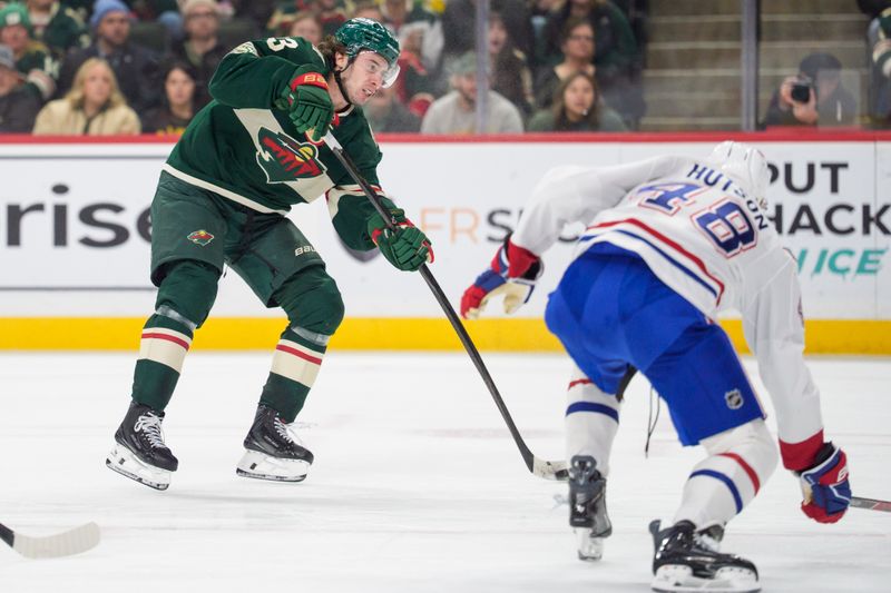 Feb 2, 2026; Saint Paul, Minnesota, USA; Minnesota Wild defenseman Quinn Hughes (43) shoots by the defense of Montreal Canadiens defenseman Lane Hutson (48) in the second period at Grand Casino Arena. Mandatory Credit: Matt Blewett-Imagn Images