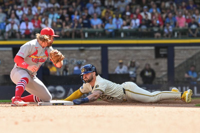 Sep 2, 2024; Milwaukee, Wisconsin, USA;  Milwaukee Brewers center fielder Garrett Mitchell (5) steals second base before tag by St. Louis Cardinals second baseman Brendan Donovan (33) in the fourth inning at American Family Field. Mandatory Credit: Benny Sieu-USA TODAY Sports