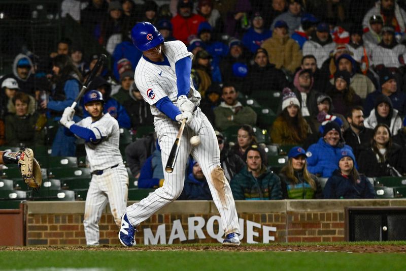 Apr 2, 2024; Chicago, Illinois, USA; Chicago Cubs first baseman Garrett Cooper (41) hits a three run homer run against the Colorado Rockies during the sixth inning at Wrigley Field. Mandatory Credit: Matt Marton-USA TODAY Sports