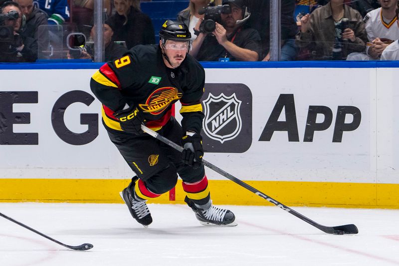 Oct 26, 2024; Vancouver, British Columbia, CAN;  Vancouver Canucks forward J.T. Miller (9) handles the puck against the Pittsburgh Penguins during the first period at Rogers Arena. Mandatory Credit: Bob Frid-Imagn Images