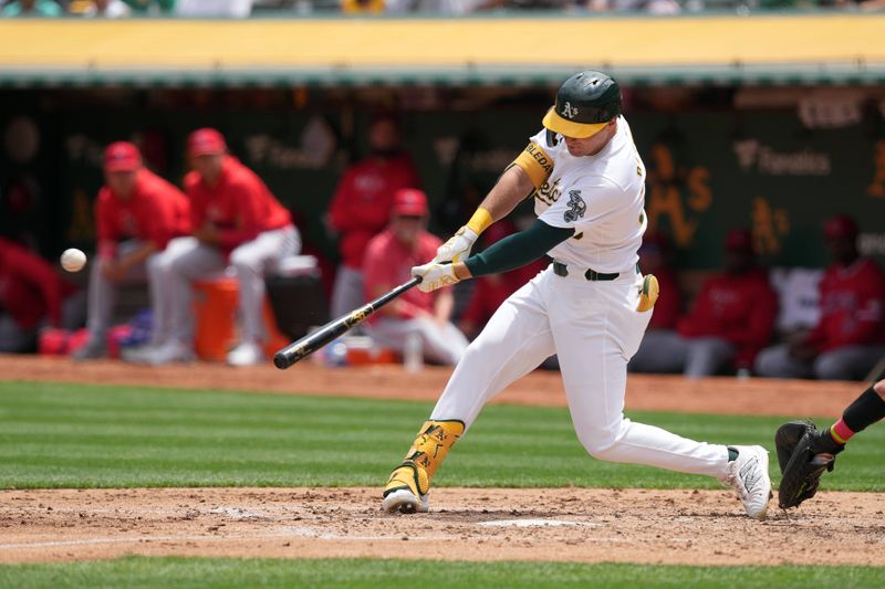 Jul 21, 2024; Oakland, California, USA; Oakland Athletics center fielder JJ Bleday (33) hits an RBI double against the Los Angeles Angels during the third inning at Oakland-Alameda County Coliseum. Mandatory Credit: Darren Yamashita-USA TODAY Sports