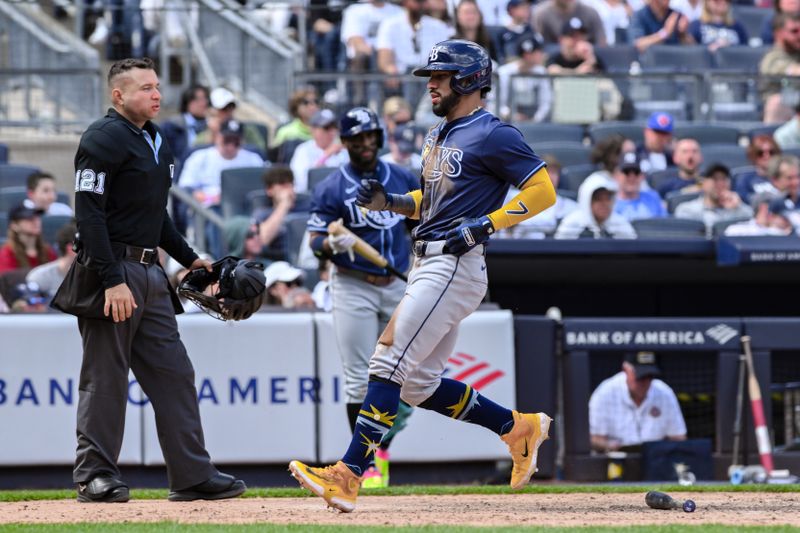 Apr 20, 2024; Bronx, New York, USA; Tampa Bay Rays shortstop José Caballero (7) scores a run during the tenth inning against the New York Yankees at Yankee Stadium. Mandatory Credit: John Jones-USA TODAY Sports