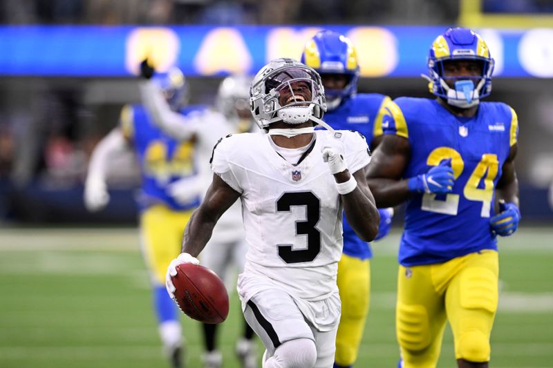 Las Vegas Raiders' DeAndre Carter smiles as he runs with the football after stepping out of bounds during the first half of a preseason NFL football game against the Los Angeles Rams Saturday, Aug. 19, 2023, in Inglewood, Calif. (AP Photo/Alex Gallardo)