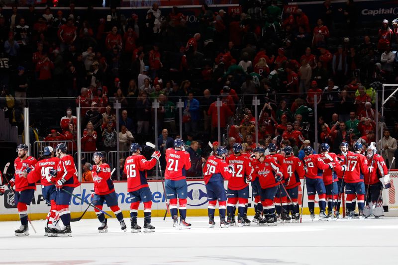 Oct 17, 2024; Washington, District of Columbia, USA; Washington Capitals players celebrate after their game against the Dallas Stars at Capital One Arena. Mandatory Credit: Geoff Burke-Imagn Images