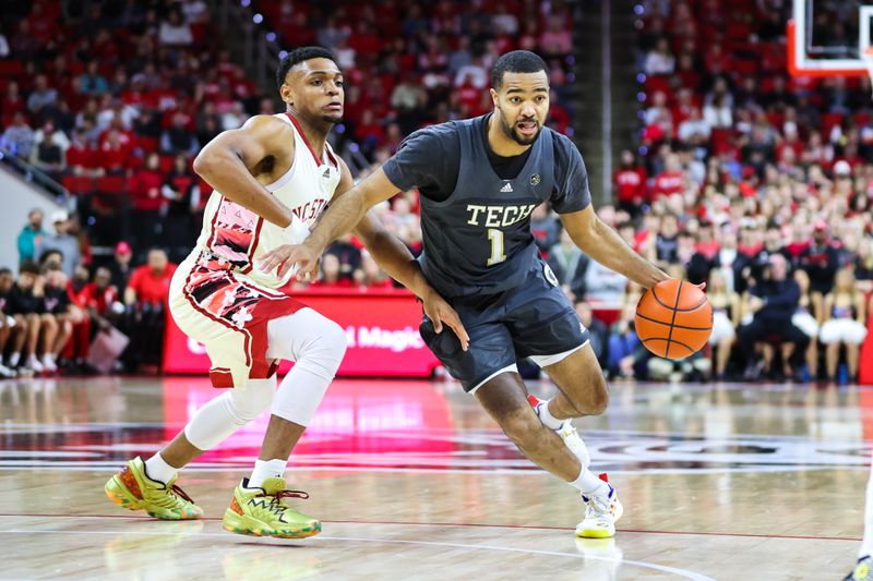 Feb 4, 2023; Raleigh, North Carolina, USA; Georgia Tech Yellow Jackets guard Kyle Sturdivant (1) dribbles the ball with North Carolina State Wolfpack guard Casey Morsell (14) close behind during the second half of the game at PNC Arena. Mandatory Credit: Jaylynn Nash-USA TODAY Sports