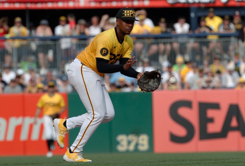 Jun 22, 2024; Pittsburgh, Pennsylvania, USA;  Pittsburgh Pirates third baseman Ke'Bryan Hayes (13) fields a ground ball for an out against the Tampa Bay Rays during the ninth inning at PNC Park. The Pirates won 4-3. Mandatory Credit: Charles LeClaire-USA TODAY Sports