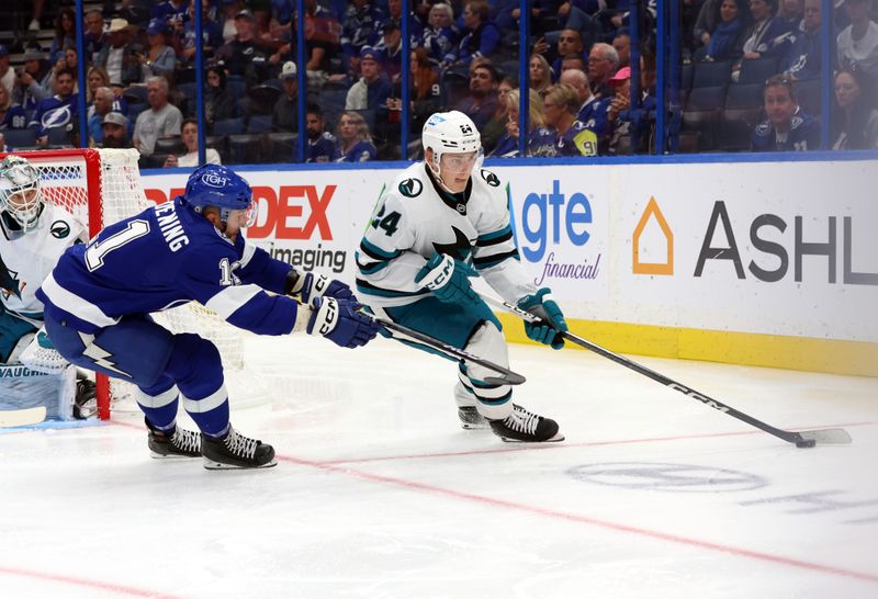 Oct 26, 2023; Tampa, Florida, USA; San Jose Sharks center Jacob Peterson (24) skates with the puck as Tampa Bay Lightning center Luke Glendening (11) defends during the third period at Amalie Arena. Mandatory Credit: Kim Klement Neitzel-USA TODAY Sports