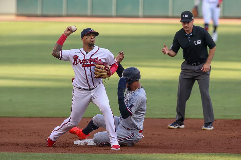 Jun 27, 2023; Atlanta, Georgia, USA; Atlanta Braves shortstop Orlando Arcia (11) turns a double play over Minnesota Twins designated hitter Byron Buxton (25) in the first inning at Truist Park. Mandatory Credit: Brett Davis-USA TODAY Sports