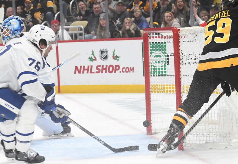 Nov 25, 2023; Pittsburgh, Pennsylvania, USA; Pittsburgh Penguins left wing Jake Guentzel (59) scores against the Toronto Maple Leafs during the first period at PPG Paints Arena. Mandatory Credit: Philip G. Pavely-USA TODAY Sports