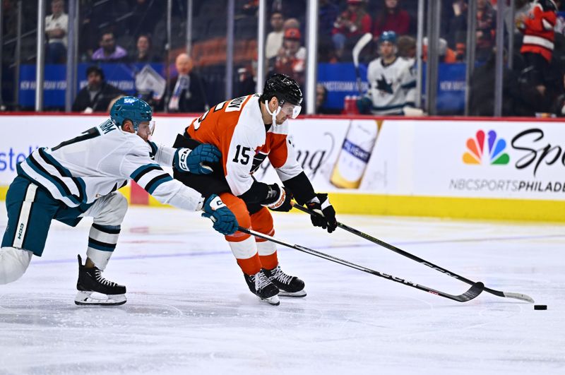 Mar 12, 2024; Philadelphia, Pennsylvania, USA; Philadelphia Flyers defenseman Denis Gurianov (15) and San Jose Sharks center Nico Sturm (7) reach for the puck in the second period at Wells Fargo Center. Mandatory Credit: Kyle Ross-USA TODAY Sports