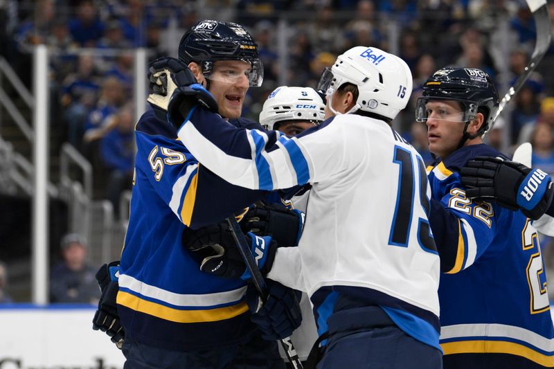 Oct 22, 2024; St. Louis, Missouri, USA; St. Louis Blues defenseman Colton Parayko (55) gets physical with Winnipeg Jets center Rasmus Kupari (15) during the first period at Enterprise Center. Mandatory Credit: Jeff Le-Imagn Images 