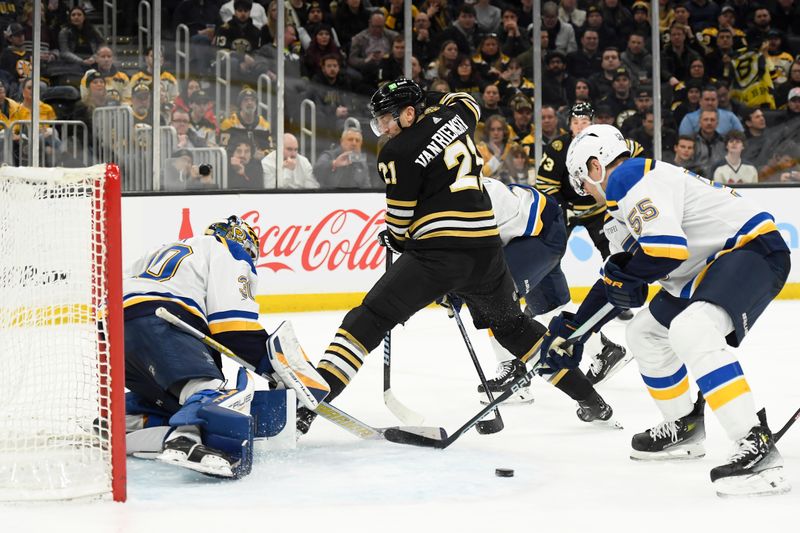 Mar 11, 2024; Boston, Massachusetts, USA;  Boston Bruins left wing James van Riemsdyk (21) passed the puck between his legs while St. Louis Blues defenseman Colton Parayko (55) defends during the third period at TD Garden. Mandatory Credit: Bob DeChiara-USA TODAY Sports