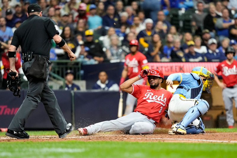 Aug 9, 2024; Milwaukee, Wisconsin, USA;  Cincinnati Reds designated hitter Jeimer Candelario (3) is tagged out sliding into home by Milwaukee Brewers catcher William Contreras (24) during the seventh inning at American Family Field. Mandatory Credit: Jeff Hanisch-USA TODAY Sports