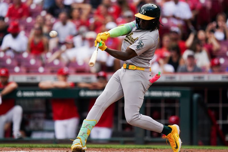 Aug 29, 2024; Cincinnati, Ohio, USA;  Oakland Athletics right fielder Lawrence Butler (4) hits the ball during the fourth inning of the MLB game between the Cincinnati Reds and Oakland Athletics, Thursday, Aug. 29, 2024, at Cintas Center in Cincinnati. Mandatory Credit: Frank Bowen IV/The Cincinnati Enquirer-USA TODAY Sports