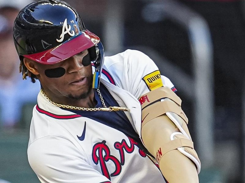 Apr 23, 2024; Cumberland, Georgia, USA; Atlanta Braves outfielder Ronald Acuna Jr. (13) doubles against the Miami Marlins during the first inning at Truist Park. Mandatory Credit: Dale Zanine-USA TODAY Sports