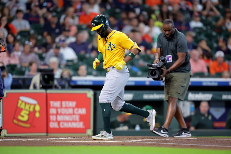 Jul 27, 2025; Houston, Texas, USA;  Athletics third baseman Miguel Andujar (22) crosses home plate after hitting a home run to right field against the Houston Astros during the first inning at Daikin Park. Mandatory Credit: Erik Williams-Imagn Images
