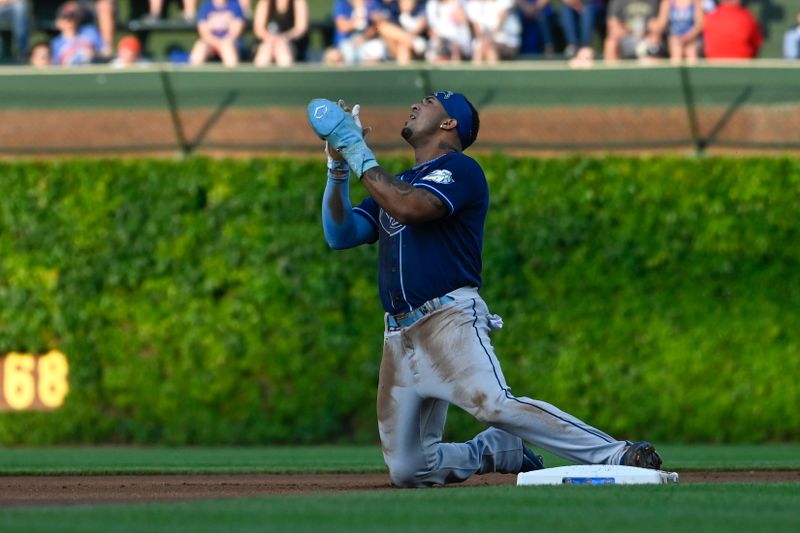 May 30, 2023; Chicago, Illinois, USA;  Tampa Bay Rays shortstop Wander Franco (5) loses his helmet while stealing second base against the Chicago Cubs during the first inning at Wrigley Field. Mandatory Credit: Matt Marton-USA TODAY Sports