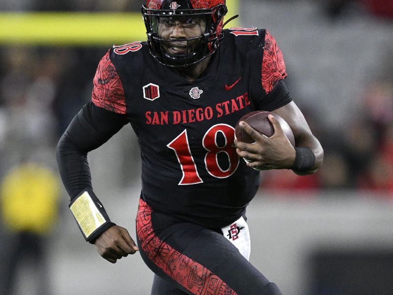 Nov 25, 2023; San Diego, California, USA; San Diego State Aztecs quarterback Jalen Mayden (18) runs the ball during the first half against the Fresno State Bulldogs at Snapdragon Stadium. Mandatory Credit: Orlando Ramirez-USA TODAY Sports