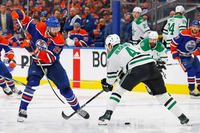 May 27, 2024; Edmonton, Alberta, CAN;   Edmonton Oilers forward Leon Draisaitl (29) tries to move the puck past Dallas Stars defensemen Miro Heiskanen (4)during the third period in game three of the Western Conference Final of the 2024 Stanley Cup Playoffs at Rogers Place. Mandatory Credit: Perry Nelson-USA TODAY Sports