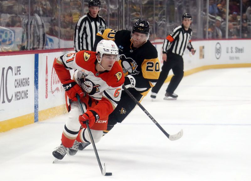 Oct 31, 2024; Pittsburgh, Pennsylvania, USA;  Anaheim Ducks left wing Cutter Gauthier (61) moves the puck ahead of Pittsburgh Penguins center Lars Eller (20) during the second period at PPG Paints Arena. Mandatory Credit: Charles LeClaire-Imagn Images