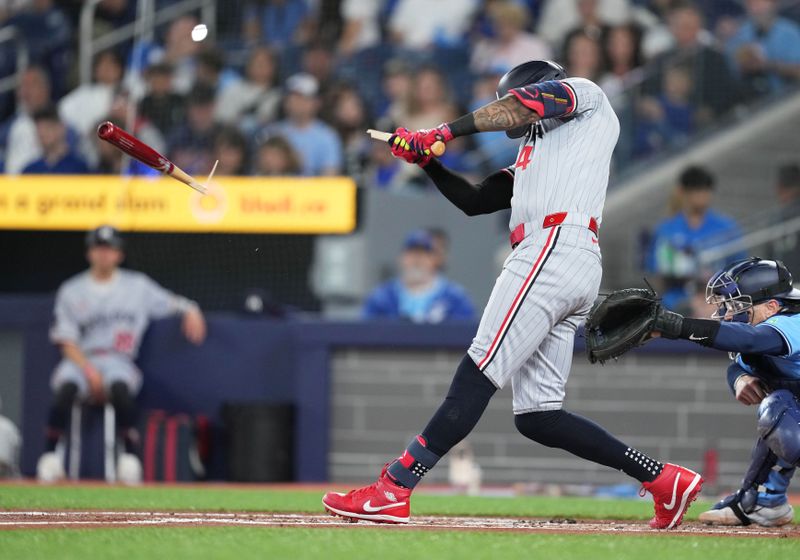 May 11, 2024; Toronto, Ontario, CAN; Minnesota Twins shortstop Carlos Correa (4) hits a broken bat RBI single against the Toronto Blue Jays during the first inning at Rogers Centre. Mandatory Credit: Nick Turchiaro-USA TODAY Sports