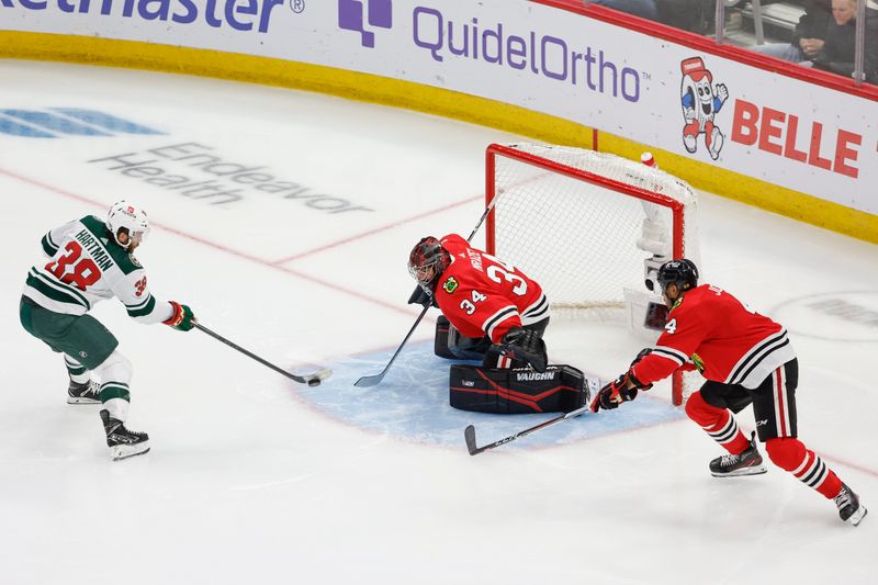 Feb 7, 2024; Chicago, Illinois, USA; Minnesota Wild right wing Ryan Hartman (38) tries to score against Chicago Blackhawks goaltender Petr Mrazek (34) during the third period at United Center. Mandatory Credit: Kamil Krzaczynski-USA TODAY Sports