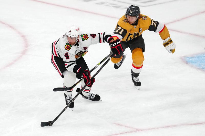 Apr 16, 2024; Las Vegas, Nevada, USA; Chicago Blackhawks defenseman Seth Jones (4) protects the puck from Vegas Golden Knights center William Karlsson (71) during the first period at T-Mobile Arena. Mandatory Credit: Stephen R. Sylvanie-USA TODAY Sports