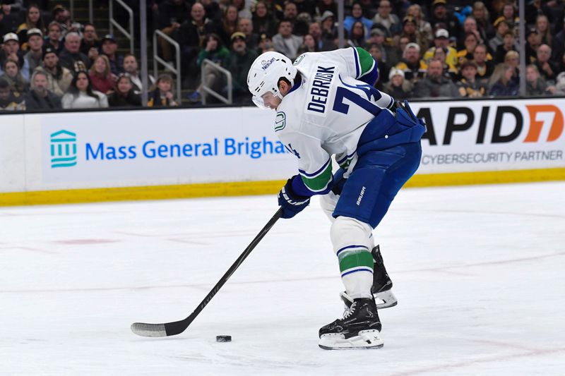 Dec 20, 2025; Boston, Massachusetts, USA;  Vancouver Canucks left wing Jake Debrusk (74) skates in a long on goal during the second period against the Boston Bruins at TD Garden. Mandatory Credit: Bob DeChiara-Imagn Images