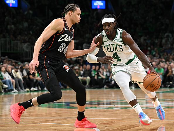 BOSTON, MASSACHUSETTS - DECEMBER 28: Jrue Holiday #4 of the Boston Celtics drives to the basket against Kevin Knox II #24 of the Detroit Pistons during the second quarter at TD Garden on December 28, 2023 in Boston, Massachusetts. NOTE TO USER: User expressly acknowledges and agrees that, by downloading and or using this photograph, User is consenting to the terms and conditions of the Getty Images License Agreement. (Photo by Brian Fluharty/Getty Images)