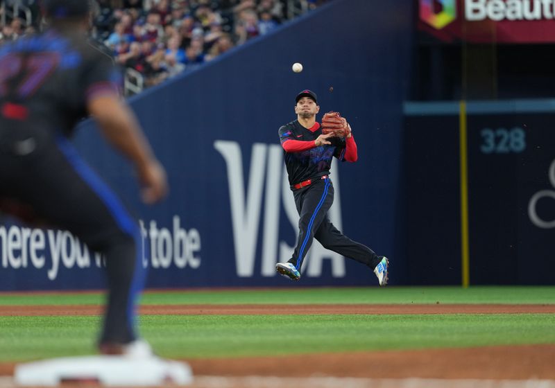 May 2, 2025; Toronto, Ontario, CAN; Toronto Blue Jays second baseman Andres Gimenez (0) throws the ball to first base for an out against the Cleveland Guardians during the fifth inning at Rogers Centre. Mandatory Credit: Nick Turchiaro-Imagn Images